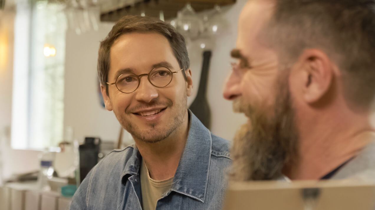 Two men having a conversation while wearing ThinOptics Vision Solutions