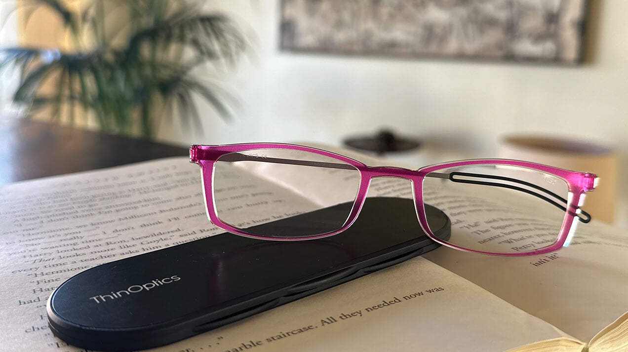 Brooklyn Reading Glasses with the Milano Case sitting on top of a book