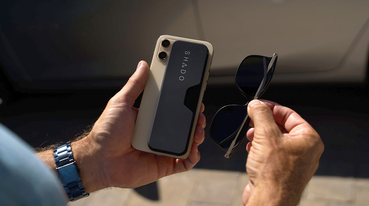 Man removing Menlo Park Sunglasses from the SHADO case on the back of his phone