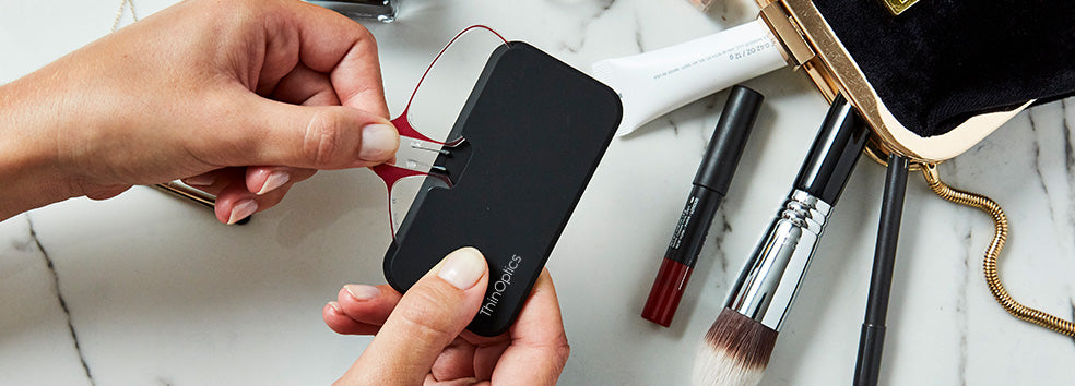 Readers with Universal Pod surrounded by contents of a makeup bag