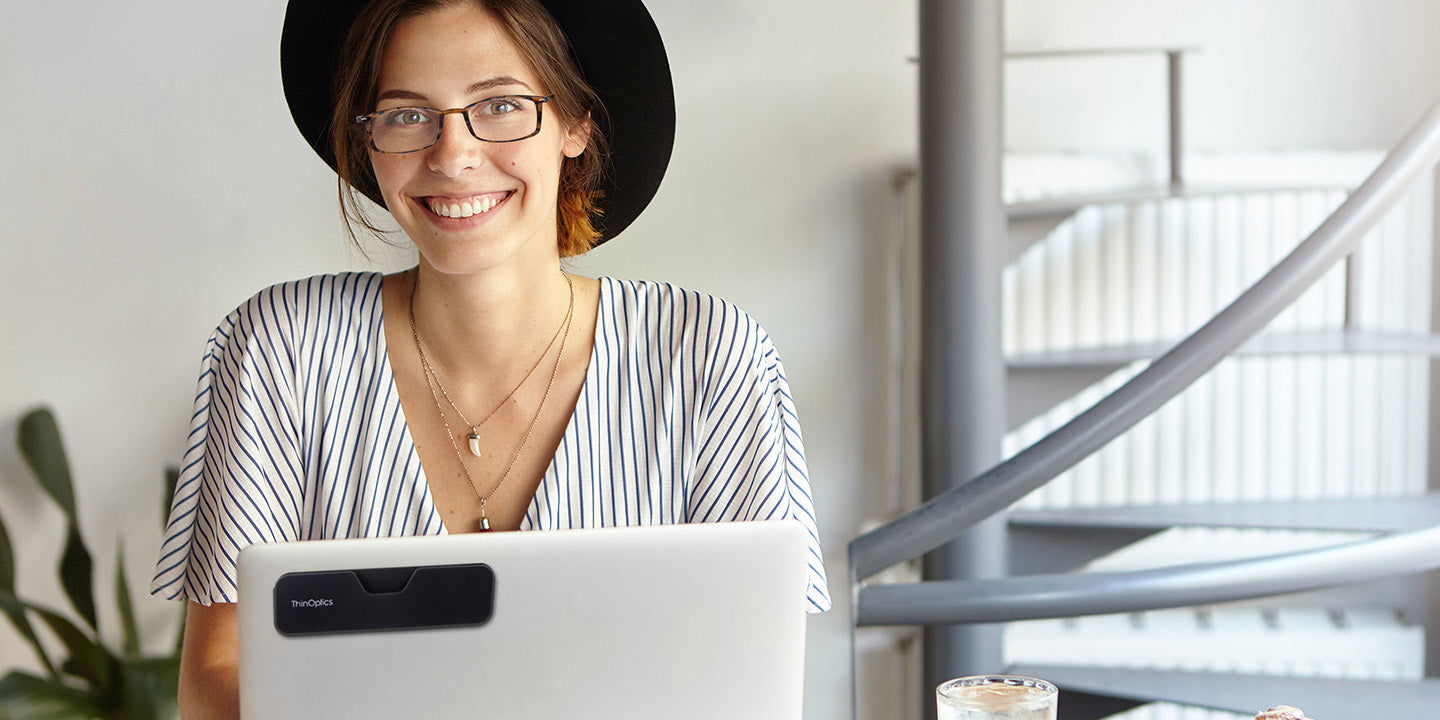 Woman wearing ThinOptics Full Frame Brooklyn Reading Glasses with Connect Case attached to laptop