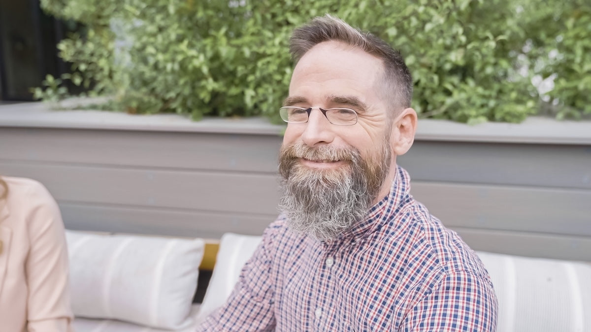 Man wearing ThinOptics Readers and smiling.