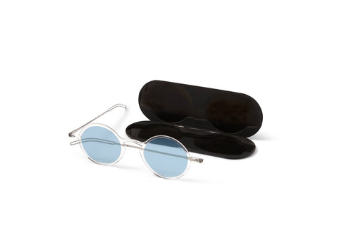 Round Manhattan Blue Light Blocking Reading Glasses next to an open Milano Case.