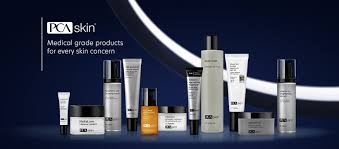 various PCA Skin products lined up next to each other in front of a dark blue background and the PCA skin logo