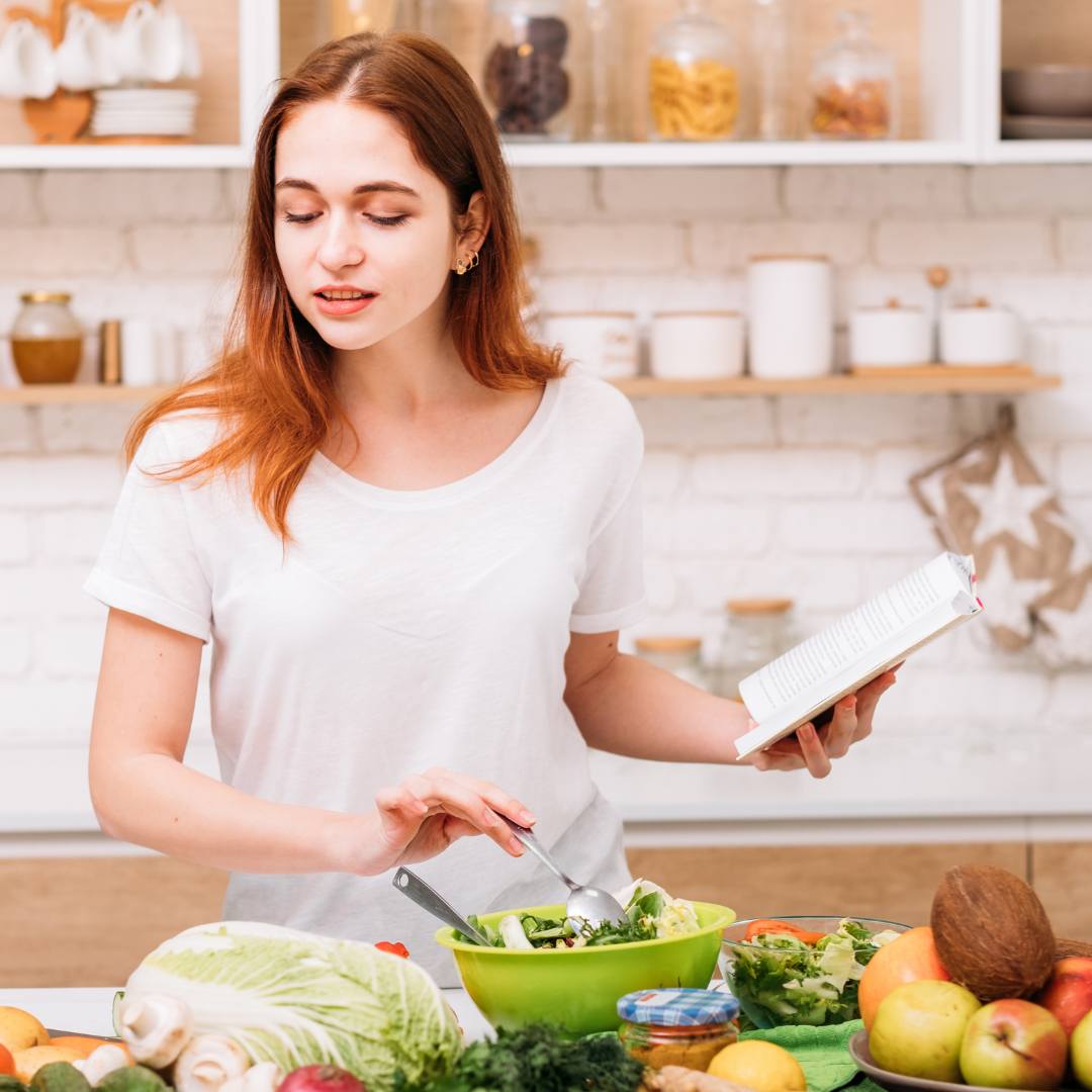 woman cooking with whole fruits and vegetables