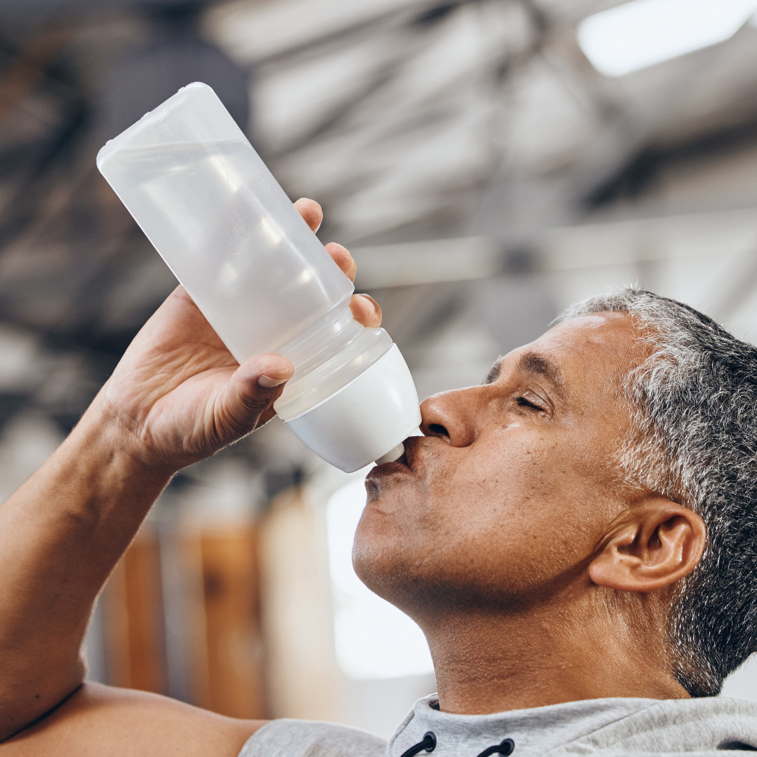 man drinking from water bottle staying hydrated