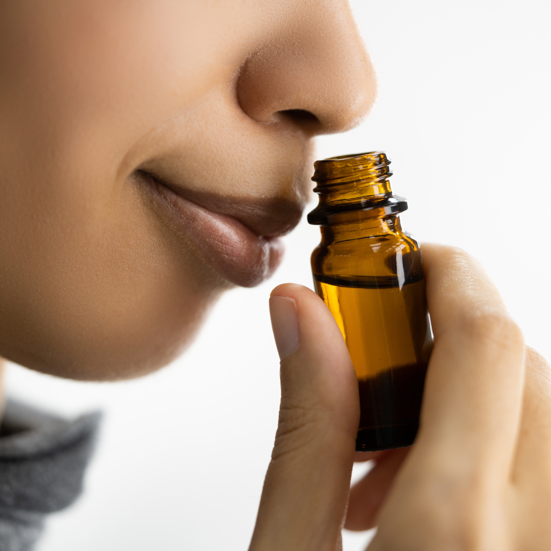 woman smelling fragrant oil