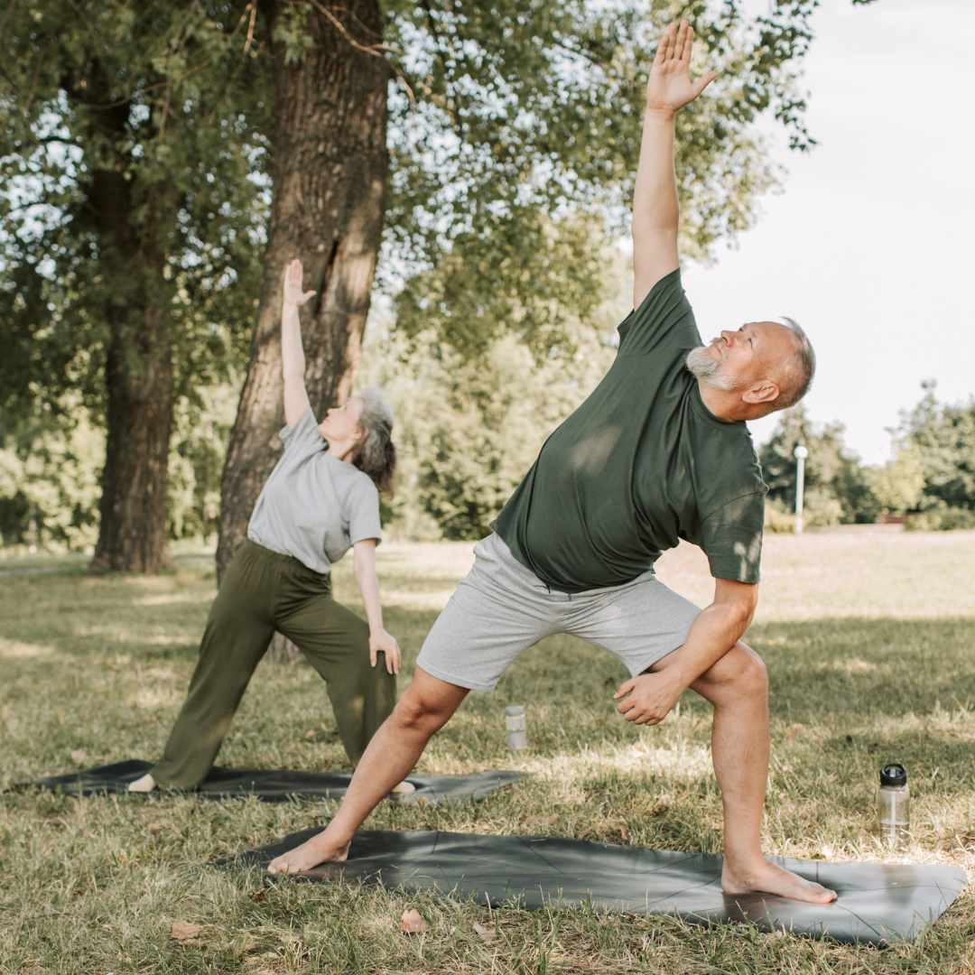 middle aged man and woman exercising in the park