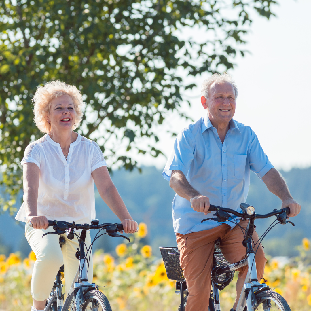 happy elderly couple enjoy a bike ride