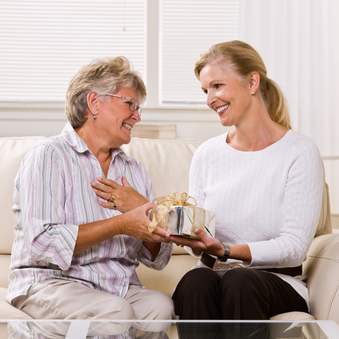 woman giving a gift to her mother for christmas