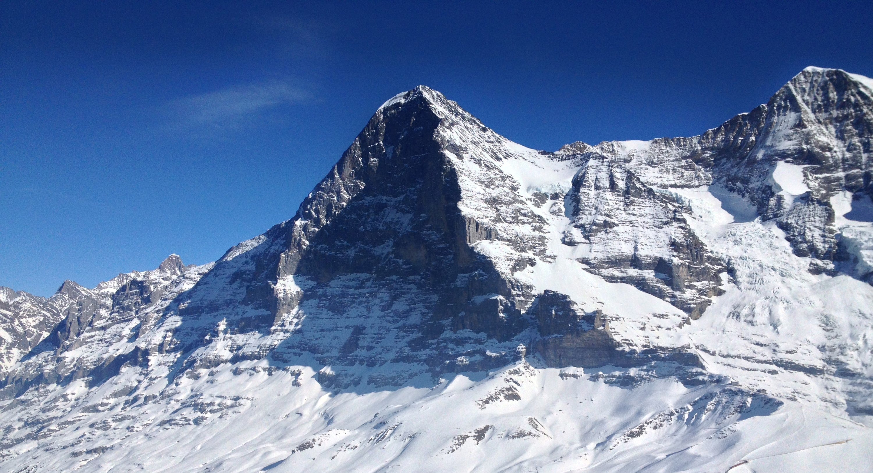 Eiger North Face in shade, blue sky and snow