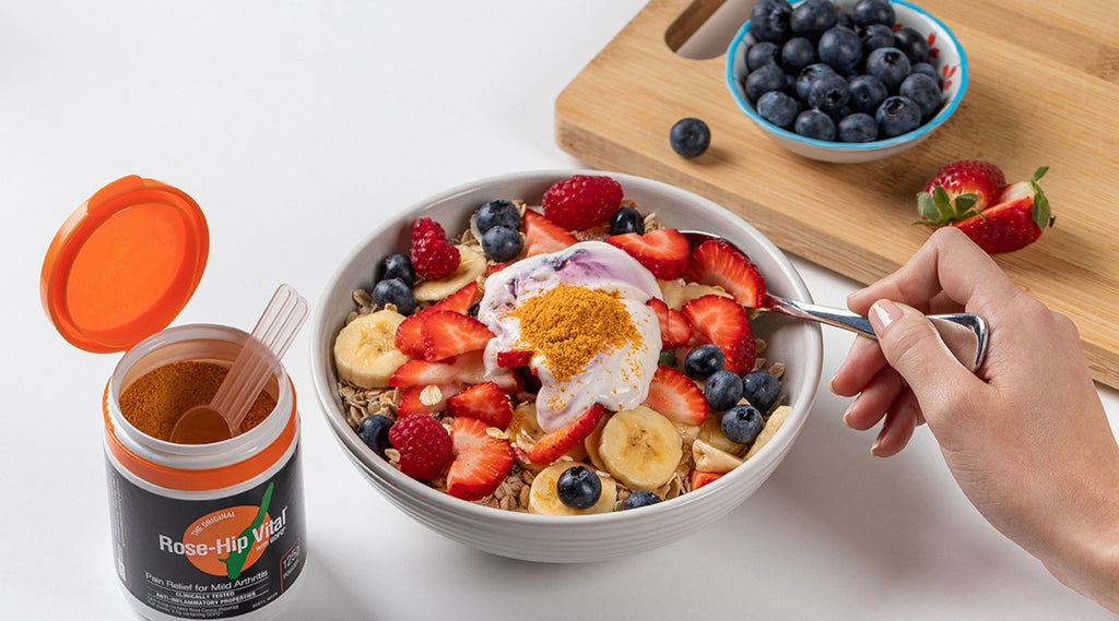 Healthy breakfast bowl with fruits, yogurt, and a sprinkle of rose-hip powder