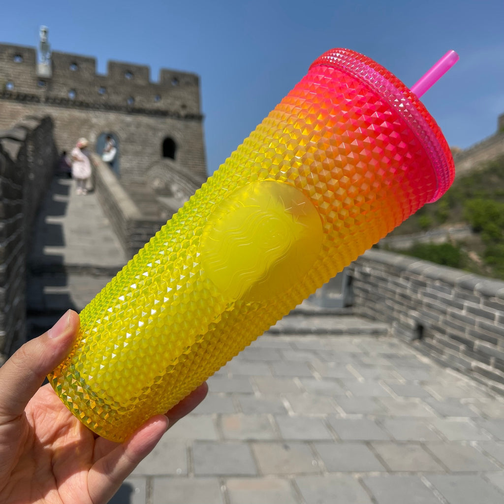 Pink starbucks cup with yellow straws on Craiyon