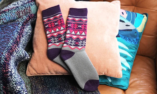 Dad gift ideas- luxury thermal socks on cushion background