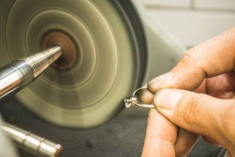 An Albuquerque jeweler uses a special tool to polish a ring after repairs. 