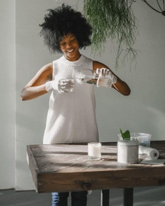 Picture of a woman pouring wax to make a candle