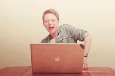 white man dancing over laptop on table gif