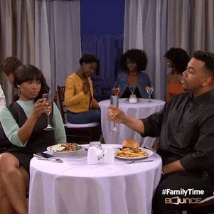 black couple cheers at dinner gif