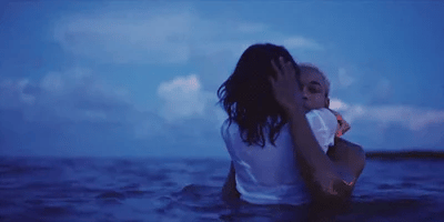 black couple hugging in water gif