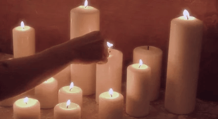 lighting lots of candles gif