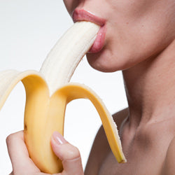 white woman eating a banana