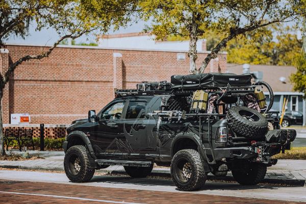 A 4x4 vehicle for overlanding is parked in the yard