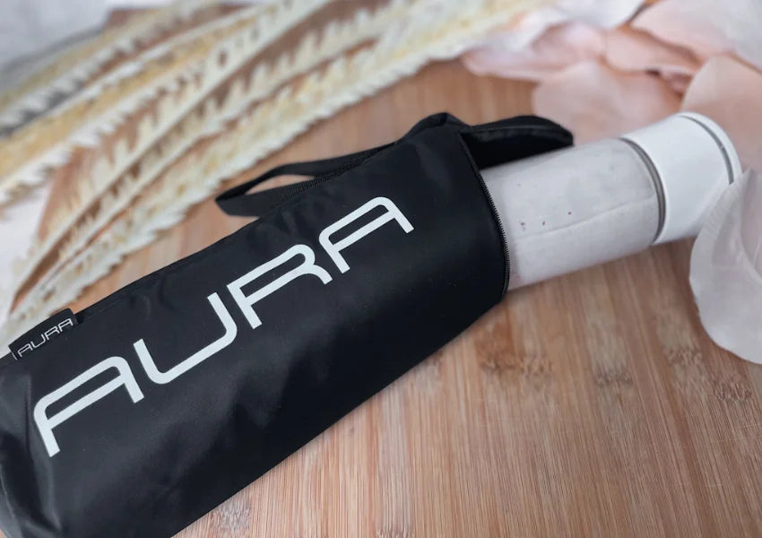 aura portable blender in an aura insulated sleeve on wooden table