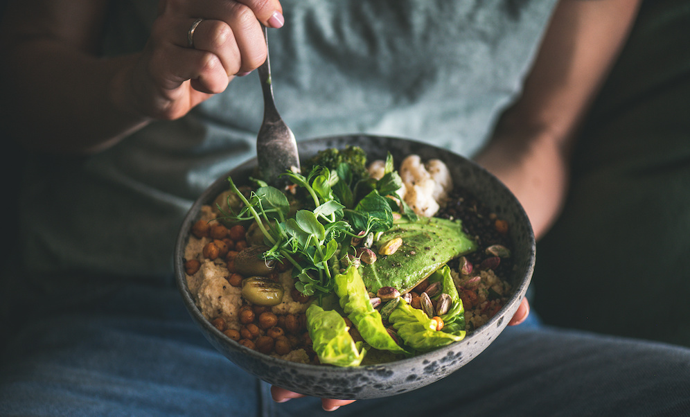 Woman holding Bowl with lots of veggies