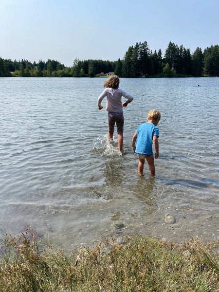 two children running into a lake