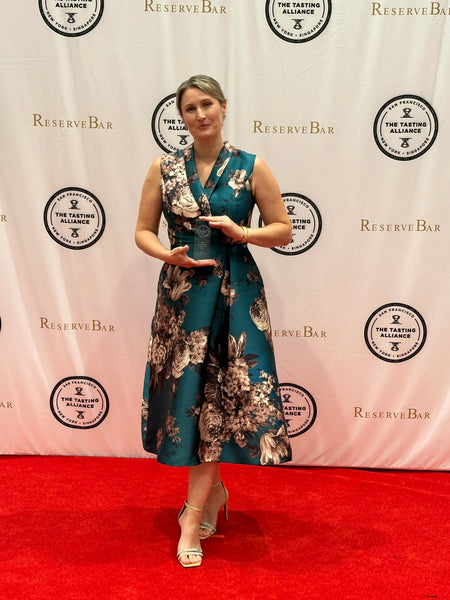 Jessica Selander Joyus non-alcoholic wine founder on a red carpet at the Top Shelf awards with holding an award for Best Nonalcoholic Wine