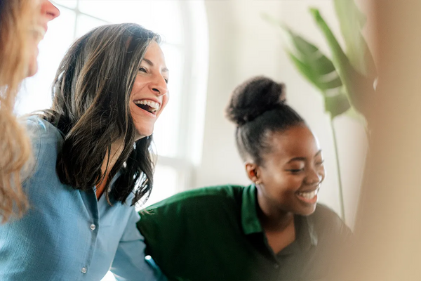 diverse people in a support group or meeting smiling