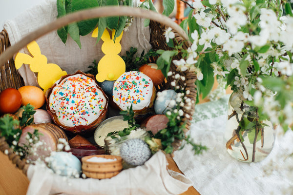 A woven Easter basket full of handmade baked goods and self-care products