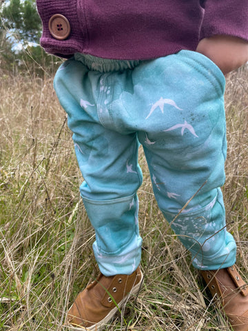 Light green pants with white birds.