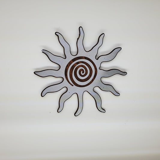 southwestern sun metal art wall decor on stained wood background. 