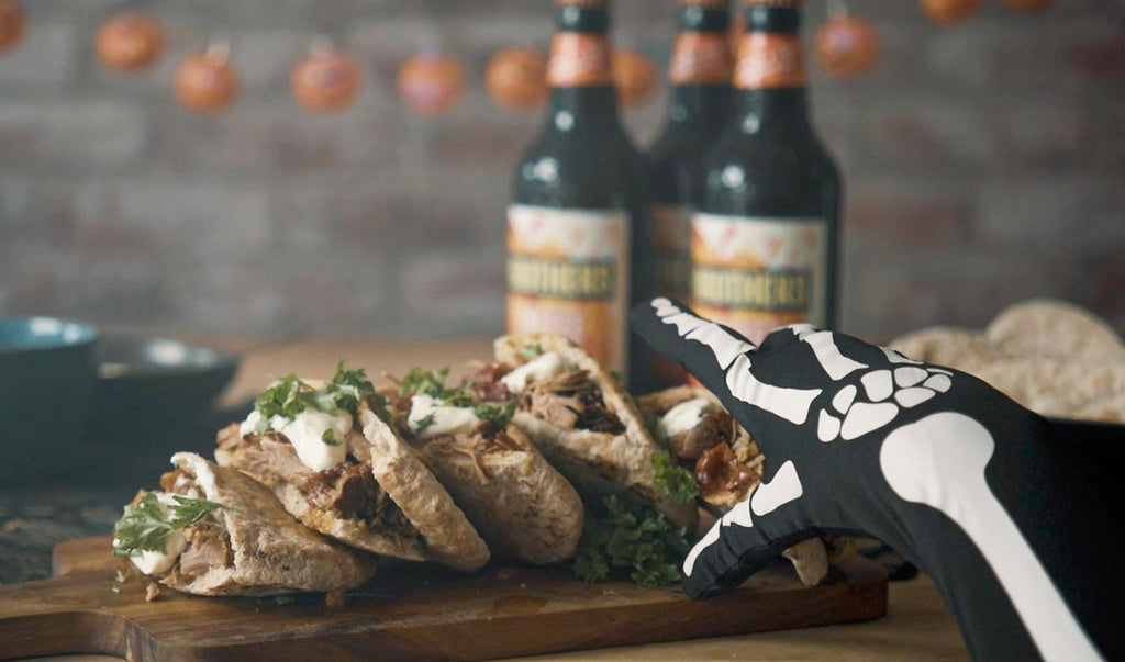 Skeleton hand reaching for a Pulled Pork & Toffee Apple Cider pitta