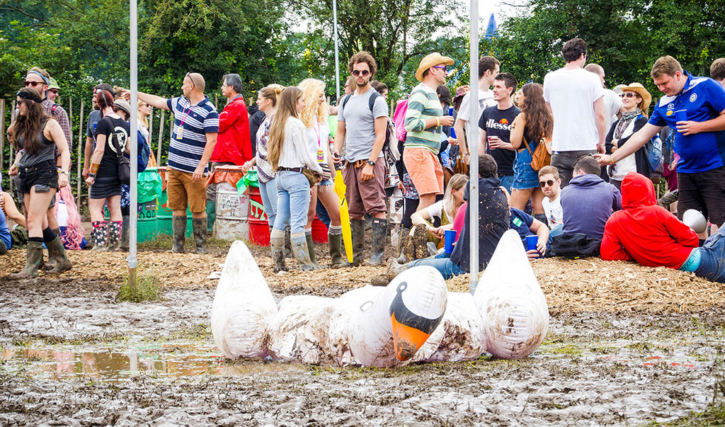 Muddy Festival with inflatable swan in puddle