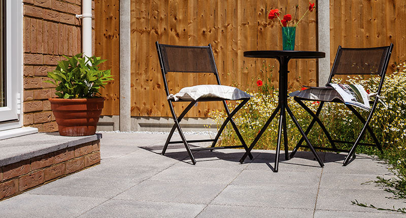Brett Chaucer garden paving with bistro style furniture a small patio