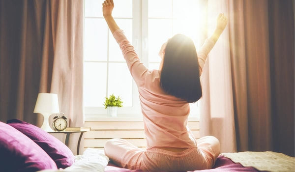 Woman Stretching in the Morning Sunlight - 7 Steps to Start Your Day with Self Care