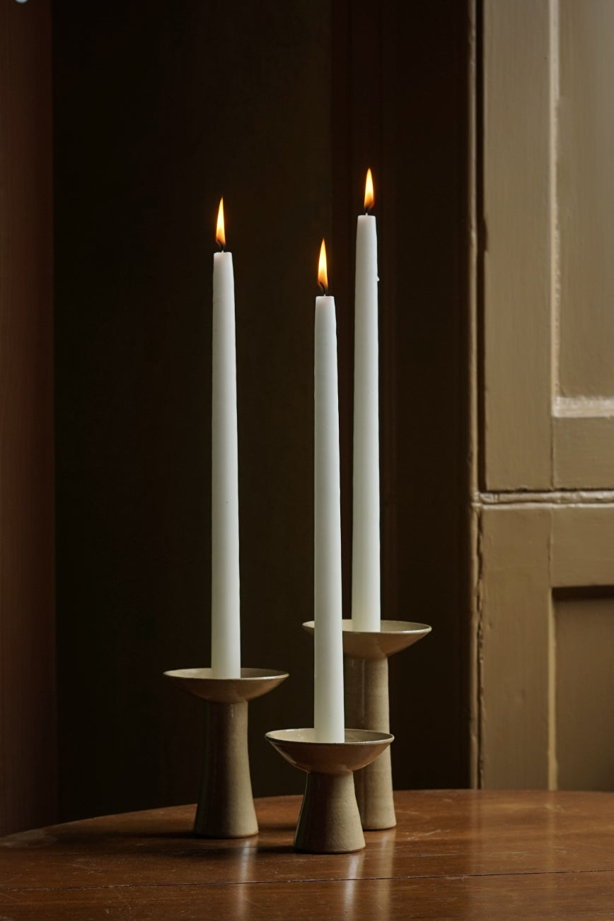 The three sizes of candlestick holding 2.5cm candles. Lit here at Bard Scotland, a shop and gallery celebrating Scottish craft and design.