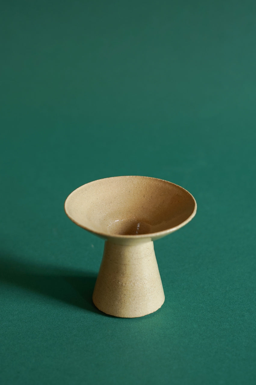 The smallest of three candlestick sizes by Cara Guthrie, in the colour clay.