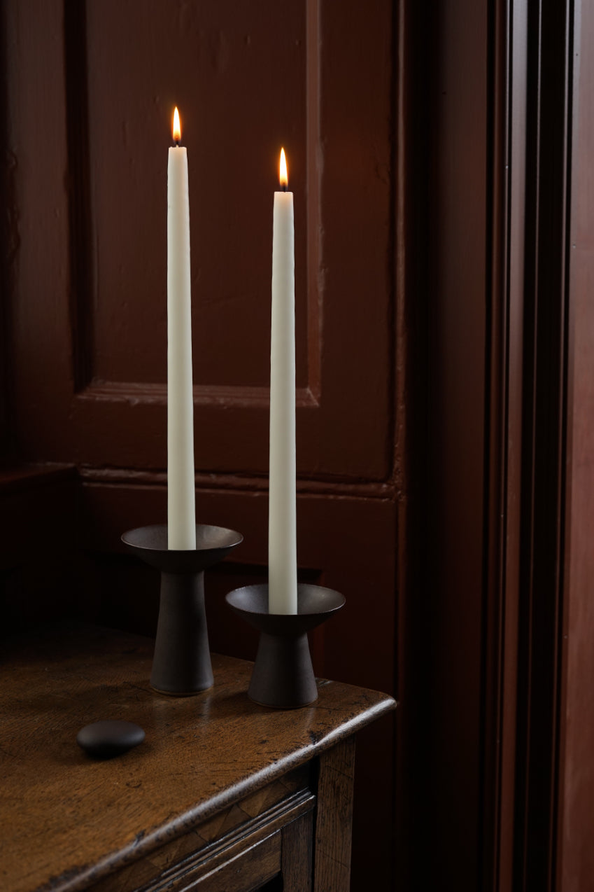 The medium and small sizes of Midsummer Candlestick in colour Iron.
