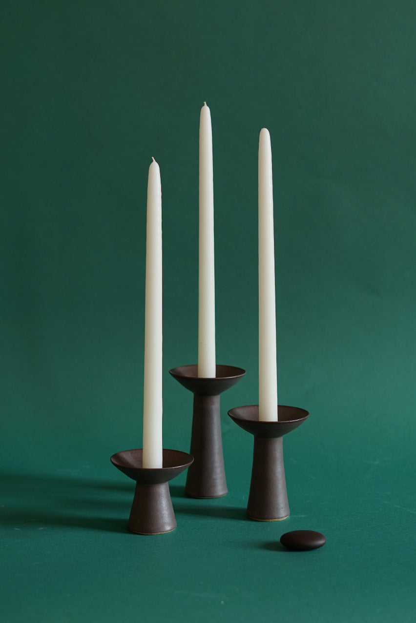 Three sizes of ceramic candlestick by Cara Guthrie.