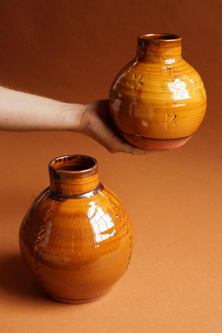 Top to bottom: Small Ochre Globe vessel is held by James, the large vessel on the table.