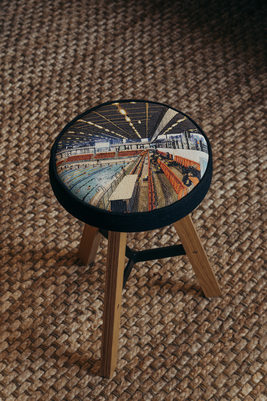  Photo of the Embroidered Commonwealth Stool by Laura Lees. Depicting Edinburgh's Royal Commonwealth Pool by RMJM.