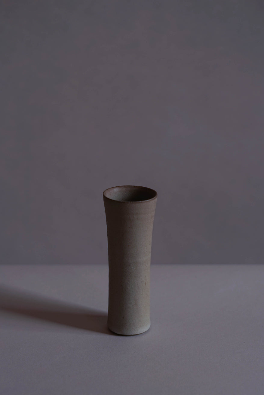 The smaller of the two sizes of ceramic vases made by Jono Smart and Emily Stephen. In Bard Grey, a custom mid grey glaze.