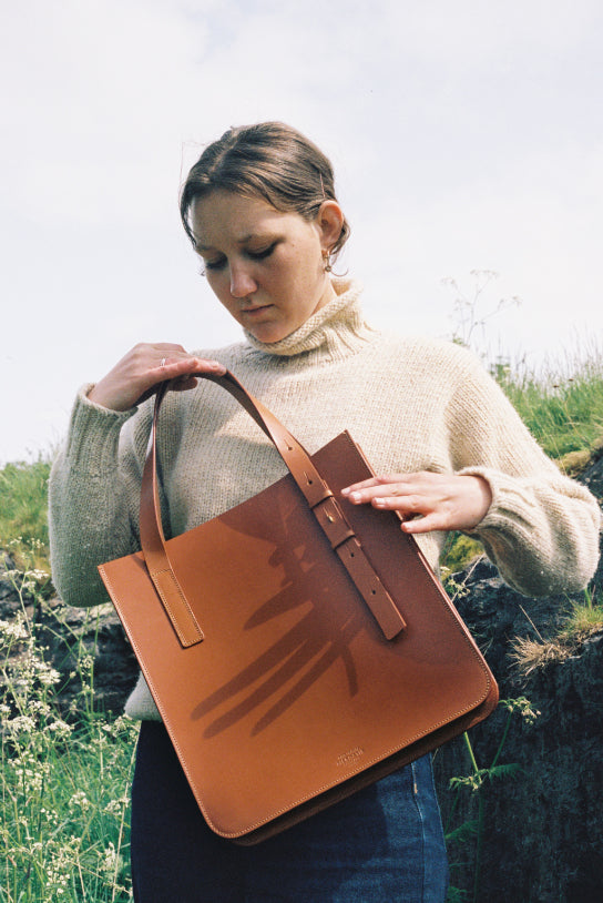 The large tan leather tote by McRostie Leather.