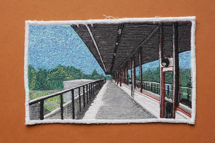  Embroidered Postcard by artist Laura Lees. This postcard shows the sidewalk of the Royal Commonwealth Pool in Edinburgh.