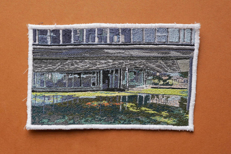  Embroidered Postcard by artist Laura Lees. This postcard depicts a scene at the Scottish Widows Headquaters.