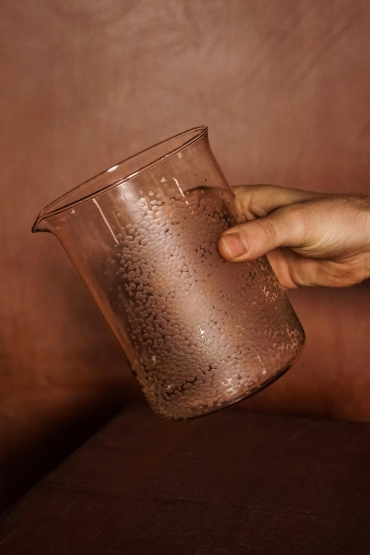  The Large Beaker, part of Second Lives by Juli Bolaños-Durman. Held by James and tipped at an angle to show its spout and textured surface.