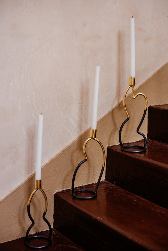 Forged candlesticks by Agnus Jones. Black, with gold leaf applied on the upper half. Shot here on the stairs at Bard.